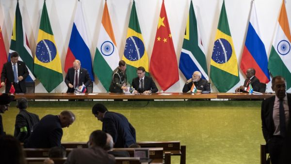 China's President Xi Jinping (L), Russia's President Vladimir Putin (2nd L), Brazil's President Jair Bolsonaro (C), India's Prime Minister Narendra Modi (2nd R), and South Africa's President Cyril Ramaphosa (R) attend to a meeting with members of the Business Council and management of the New Development Bank during the BRICS Summit in Brasilia, November 14, 2019. Pavel Golovkin / POOL / AFP