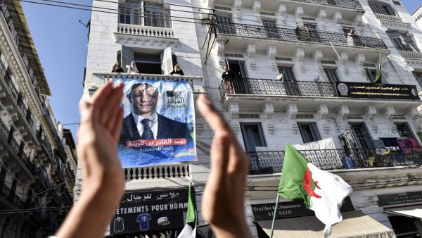 A supporters of Abdelkader Bengrina, former Algerian tourism minister and presidential candidate for the El-Bina (Construction) Islamist party, applauds outside his electoral campaign headquarters in the capital Algiers on November 17, 2019. (RYAD KRAMDI / AFP) A supporters of Abdelkader Bengrina, former Algerian tourism minister and presidential candidate for the El-Bina (Construction) Islamist party, applauds outside his electoral campaign headquarters in the capital Algiers on November 17, 2019. (RYAD KRAMDI / AFP)