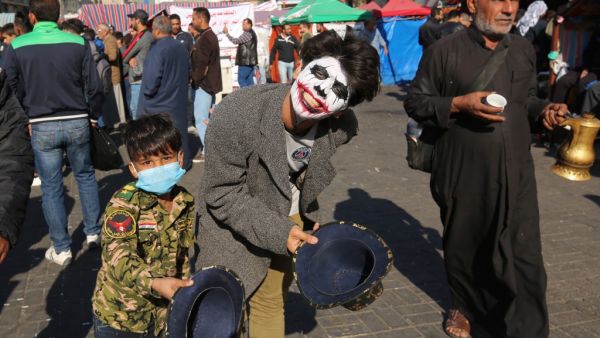 An Iraqi youth, wearing the DC comic Joker character's make up, smiles to the camera in Baghdad's Tahrir Square as anti-government protests continue across the country on November 20, 2019. (AFP/ File Photo)