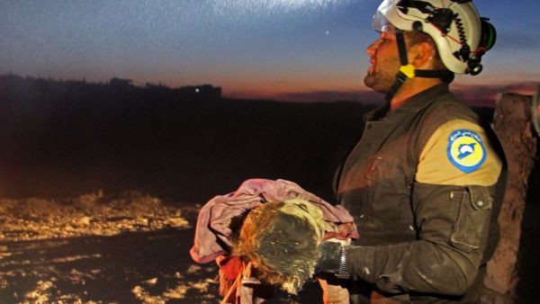 A member of the Syrian Civil Defense (White Helmets) carries a young victim following a reported Russian airstrike on the town of Maaret al-Numan in Syria's northwestern Idlib province on November 20, 2019. (AFP/ File Photo)