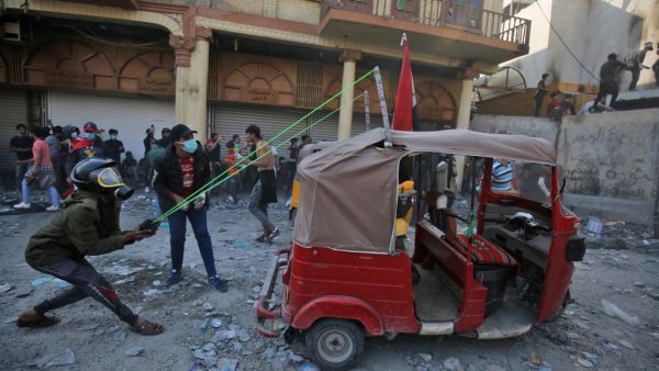 An Iraqi demonstrator uses a slingshot affixed to a tuk tuk car amid clashes with security forces in the capital Baghdad's al-Rasheed street near al-Ahrar bridge, on November 26, 2019, during ongoing anti-government demonstrations. (AFP/ File Photo)