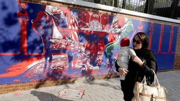 Another mural shows Iranian and American politicians sitting at a table in the White House  (AFP)