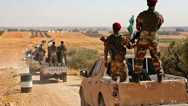 Turkish-backed Syrian rebel fighters head to an area near the Syrian-Turkish border north of Aleppo on October 8, 2019 (Nazeer Al-khatib / AFP)