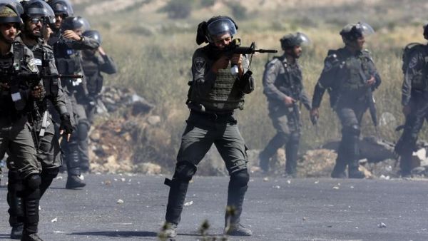 An Israeli border guard takes aim during clashes with Palestinian demonstrators in the West Bank in 2017. (AFP)