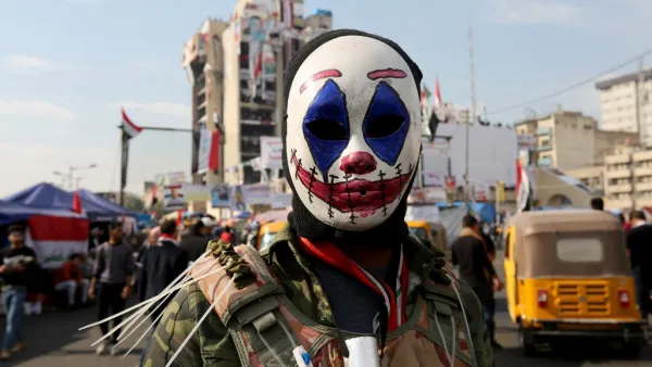 An Iraqi protester wearing the DC comic Joker character's mask poses for a picture during an anti-government demonstration in the capital Baghdad, on November 23, 2019. SABAH ARAR / AFP