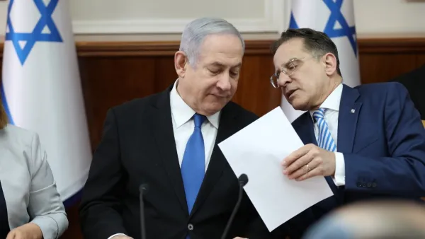Israeli Prime Minister Benjamin Netanyahu speaks with Cabinet Secretary Tzahi Braverman (R) during the weekly cabinet meeting at his office in Jerusalem on December 1, 2019. (Abir SULTAN / POOL / AFP)