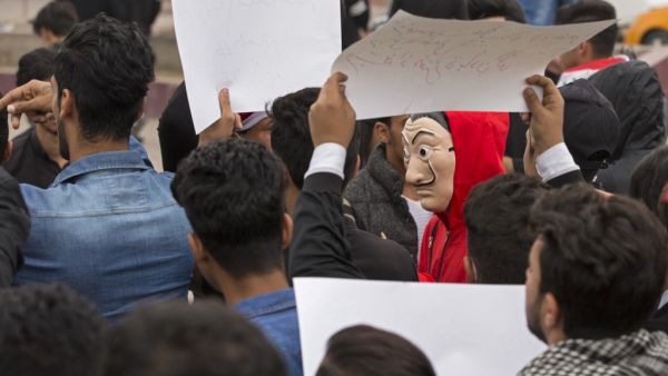 An Iraqi demonstrator wearing the red jumpsuit and Dali mask of the Spanish Netflix hit series La Casa de Papel (Money Heist), takes part in an anti-government march in the center of the southern city of Basra on December 2, 2019. (AFP/ File Photo)