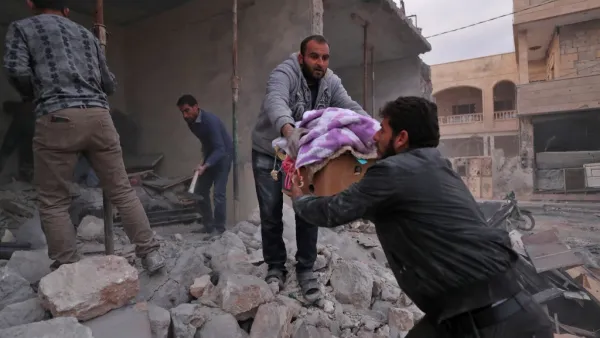 Residents salvage belongings from the rubble of a building following a reported air strike by pro-regime forces in the Syrian town of Saraqib in the northwestern Idlib province on December 4, 2019. (Omar HAJ KADOUR / AFP)