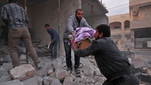 Residents salvage belongings from the rubble of a building following a reported air strike by pro-regime forces in the Syrian town of Saraqib in the northwestern Idlib province on December 4, 2019. (Omar HAJ KADOUR / AFP)