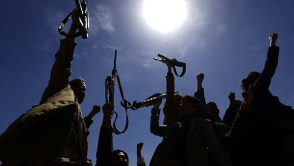 In this file photo taken on February 21, 2019, armed Yemeni men raise their weapons as they gather near the capital Sanaa to show their support to the Shiite Huthi movement against the Saudi-led intervention. (Mohammed HUWAIS / AFP)
