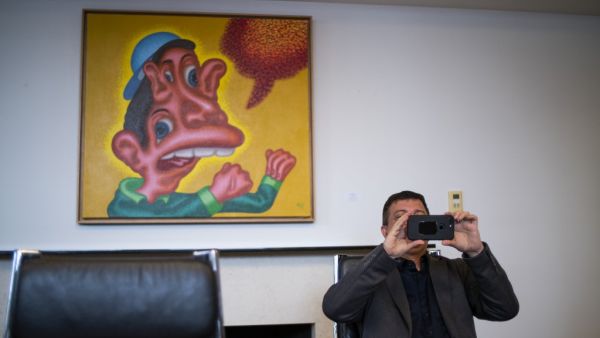 David Datuna, the performance artist who ate a banana Saturday afternoon in Miami at Art Basel, take a picture of media during a press conference on December 9, 2019 in New York. The move was bananas... or maybe the work was just too appealing. AFP