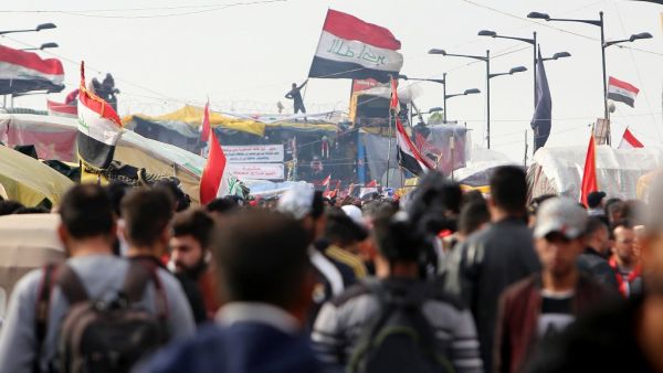 Iraqis gather at al-Sinek bridge in the capital Baghdad amid ongoing anti-government protests on December 10, 2019. SABAH ARAR / AFP