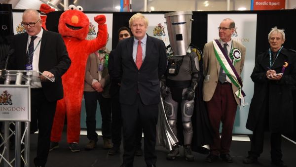 Britain's Prime Minister and Conservative leader Boris Johnson (C) reacts as the results are read out for the race to be MP for Uxbridge and Ruislip South at the count centre in Uxbridge, west London, on December 13, 2019 after votes were counted as part of the UK general election. AFP