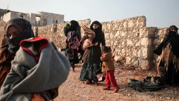 Displaced Syrians from the south of Idlib province queue to receive food aid from a truck in the countryside west of the town of Dana in the northwestern Syrian region on December 23, 2019. Aaref WATAD / AFP