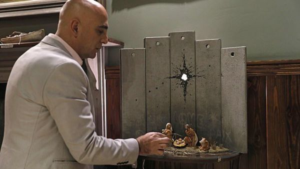 The piece has appeared in the Walled Off Hotel, Banksy's property which overlooks the border wall in the divided city (AFP)