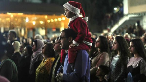 Palestinian Christians attend a Christmas tree lighting celebration in Gaza City [AFP/Getty]