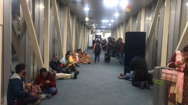 Passengers shared on social media photos of passengers sitting on the floor of the aerobridge. (Twitter)