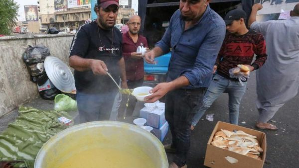 In Baghdad, demonstrators gathered on campuses and in Tahrir Square, with some coming out to support the rallies by distributing food. (AFP/ File Photo)
