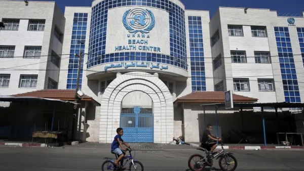 Children ride their bicycles in front of a health centre run by the United Nations Relief and Works Agency (UNRWA) in Gaza City on October 2, 2018, closed in protest against job cuts announced by the UNRWA. (AFP)