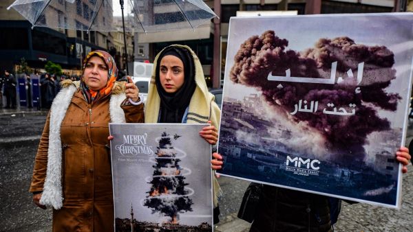 Protestors hold placards reading "bomb Christmas tree" during a protest against Syrian military operation in the rebel bastion of Idlib, northwestern Syria, taking place near the Russian Consulate, in Istanbul, on December 28, 2019.(AFP/ File Photo)