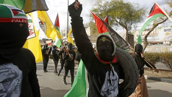 Supporters of the Palestinian Fatah movement take part in a rally marking the 55th foundation anniversary of the political party in the West Bank town of Bethlehem on January 1, 2020. Musa AL SHAER / AFP
