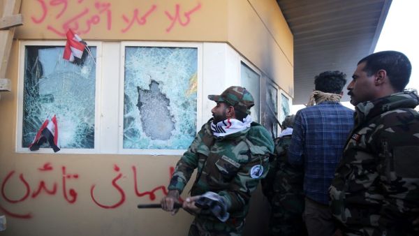 In this file photo taken on December 31, 2019, members the Hashed al-Shaabi, a mostly Shiite network of local armed groups trained and armed by powerful neighbour Iran, smash the bullet-proof glass of the US embassy's windows in Baghdad. (AFP/ File Photo) In this file photo taken on December 31, 2019, members the Hashed al-Shaabi, a mostly Shiite network of local armed groups trained and armed by powerful neighbour Iran, smash the bullet-proof glass of the US embassy's windows in Baghdad. (AFP/ File Photo)