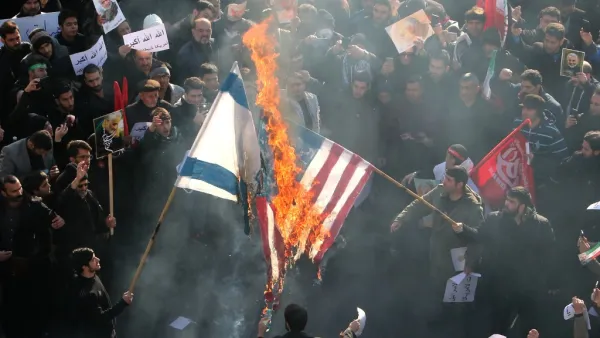 Iranians set a US and an Israeli flag on fire during a funeral procession organised to mourn the slain military commander Qasem Soleimani, Iraqi paramilitary chief Abu Mahdi al-Muhandis and other victims of a US attack in the capital Tehran on January 6, 2020. (AFP/ File Photo)