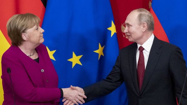 Russia's President Vladimir Putin (R) and Germany's Chancellor Angela Merkel shake hands at the end of their joint press conference after their meeting at the Kremlin in Moscow, on January 11, 2020. Pavel Golovkin / POOL / AFP