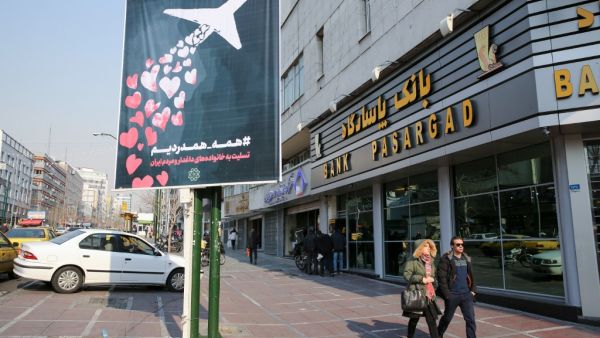 Iranians walk past a poster honouring the victims of a Ukrainian passenger jet accidentally shot down in the capital last week, in front of the Amirkabir University in the capital Tehran, on January 13, 2020. Iran's government denied a "cover-up" after it took days for the armed forces to admit a Ukrainian airliner was shot down by mistake shortly after it took off from Tehran last week, killing all 176 passengers and crew. The plane was brought down hours after Iran had launched missiles at US troops stati