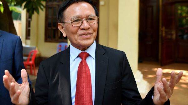 Kem Sokha, former leader of the now-banned Cambodia National Rescue Party (CNRP), speaks to media as he departs his residence for the Phnom Penh municipal court for his trial on January 15, 2020. The treason trial of Cambodian opposition leader Kem Sokha opened on January 15, more than two years after his arrest in a case decried by his family as a "farce" and described by the US as politically motivated.  TANG CHHIN Sothy / AFP