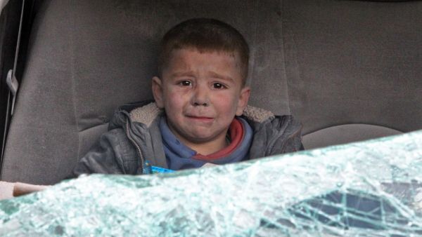A Syrian boy cries as he is evacuated after a regime air strike on Ariha town in Syria's last major opposition bastion of Idlib on January 15, 2020. At least 20 other civilians were wounded in the raids that struck a bustling area of Idlib city, capital of the rebel-held province of the same name, said the Syrian Observatory for Human Rights. Abdulaziz KETAZ / AFP