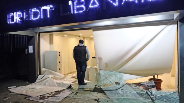 A man stands at the entrance of bank that was vandalised by anti-government protesters in the capital Beirut overnight on January 16, 2020. (AFP/ File Photo)