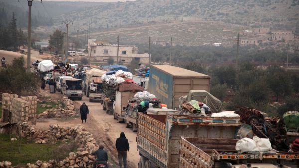 Syrians fleeing towns and villages in the countryside of the northern province of Aleppo drive through the town of Ghazaouia on January 18, 2020, toward safer areas to seek refuge from reported bombing by pro-regime forces. Aaref WATAD / AFP