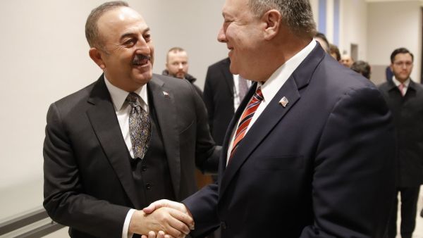 Turkish Foreign Minister Mevlut Cavusoglu (L) shakes hands with US Secretary of State Mike Pompeo as they arrive for a bi-lateral meeting prior a Peace summit on Libya in Berlin on January 19, 2020. AFP