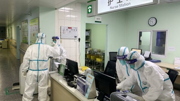 This photo taken on January 22, 2020 shows medical staff members wearing protective suits at the Zhongnan hospital in Wuhan in China's central Hubei province. China banned trains and planes from leaving Wuhan at the centre of a virus outbreak on January 23. (AFP/ File Photo)