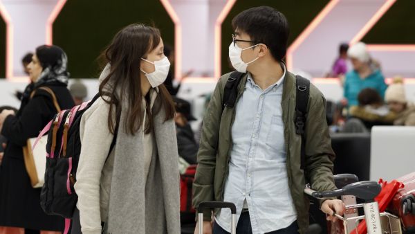 Travellers are seen wearing masks at the international arrivals area at the Toronto Pearson Airport in Toronto, Canada, January 26, 2020. Toronto Public Health confirmed Saturday that a case of the novel coronavirus that originated in Wuhan, China is currently being treated in a Toronto Hospital. Cole BURSTON / AFP