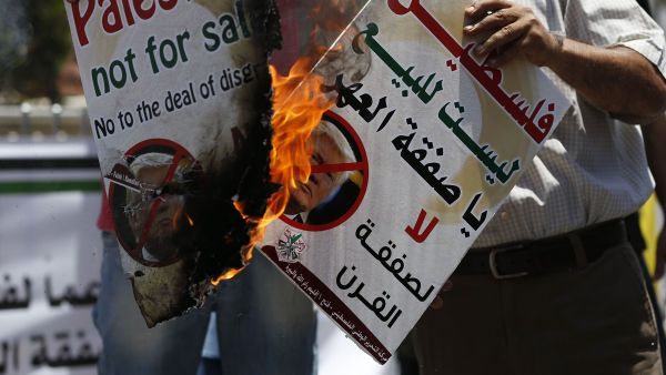 Palestinians protest against Trump's deal of the century in the West Bank city of Ramallah on 2 July 2018 [Abbas Momani/AFP/Getty Images]