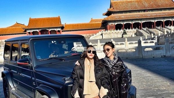 These two Chinese tourists have caused outrage by posing inside the Forbidden City in Beijing with their £100,000 Mercedes G-Wagen. (Facebook)