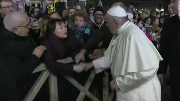 The 83-year-old pope was greeting the faithful in St Peter's Square yesterday when a woman yanked his arm. (Twitter)