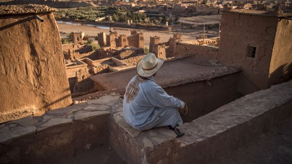 A man sits atop the Kasbah (ancient fortress) of Ait-Ben-Haddou, where scenes depicting the fictional city of Yunkai from the hit HBO television series "Game of Thrones" were filmed, about 32 kilometres northwest of the city of Ouarzazate south of Morocco's High Atlas mountains on January 27, 2020. AFP