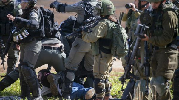Israeli soldiers arrest a Palestinian protester during a demonstration against a US brokered Middle East peace plan near the West Bank village of Tamun near the Jordan Valley on January 31, 2020. AFP