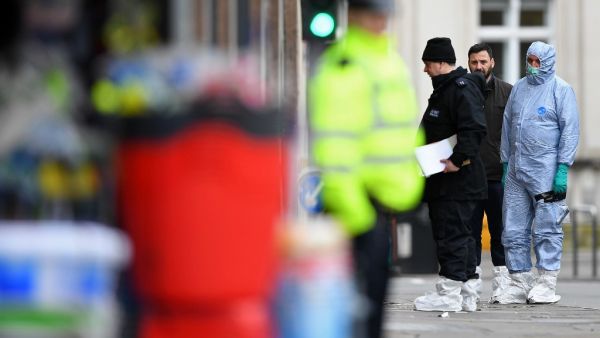 Police forensic officers work outside of a Boots store on Streatham High Road in south London on February 3, 2020, after a man was shot dead by police on February 2, following reports he had stabbed two people. AFP