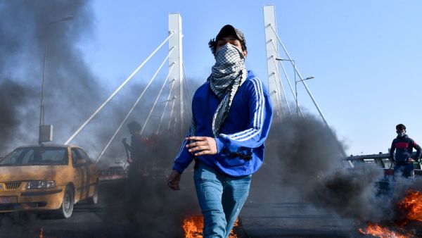 Iraqi anti-government protesters burn tyres to block the "bridge of civilizations" in the southern city of Nasiriyah, on February 6, 2020. Anti-government protesters vowed to push on with their wave off rallies as they buried seven fellow activists killed overnight in violence blamed on supporters of Shiite Muslim cleric Moqtada Sadr, a militiaman-turned-politician with a cult-like following, who raided a protest camp in Iraq's shrine city of Najaf late on February 5. Asaad NIAZI / AFP