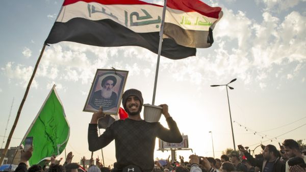 An Iraqi demonstrator carries a portrait of Grand Ayatollah Ali Sistani during an anti-government demonstration in the southern city of Basra on February 7, 2020. AFP/ File