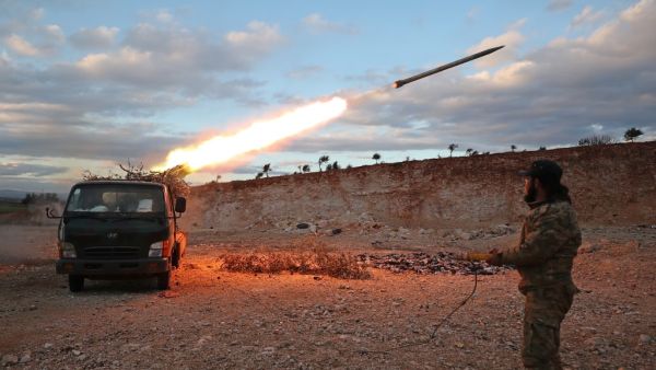 A Syrian rebel fighter fires a Grad rocket towards government forces in northwestern Syria on February 8, 2020. Since December, government forces have pressed a blistering assault against the Idlib region with Russian support, retaking town after town despite warnings from rebel ally Turkey to back off. Omar HAJ KADOUR / AFPq