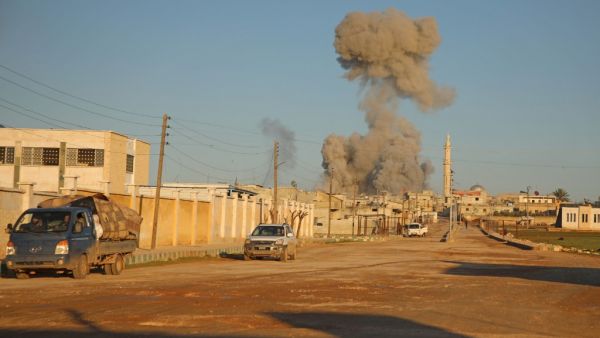 Syrians flee as smoke billows following a reported air strike by Syrian government forces in the village of Kafr Nuran in the northern province of Aleppo on February 9, 2020. AAREF WATAD / AFP