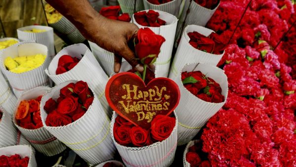 A florist arranges roses flowers at a shop ahead of Valentine's Day in Chennai on February 11, 2020. Arun SANKAR / AFP