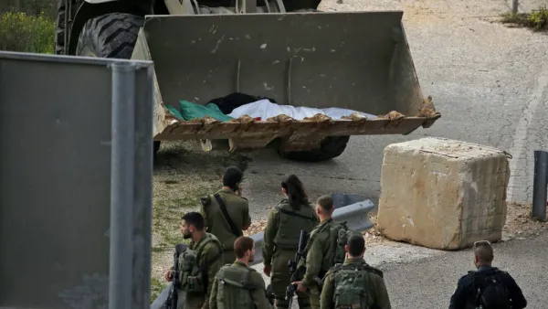 Israeli soldiers retrieve the body of a Palestinian in the village of Ras Karkar, near Ramallah in the occupied West Bank on February 17, 2020, reported to be the body of a man who wounded an Israeli soldier in a shooting attack ten days ago. ABBAS MOMANI / AFP
