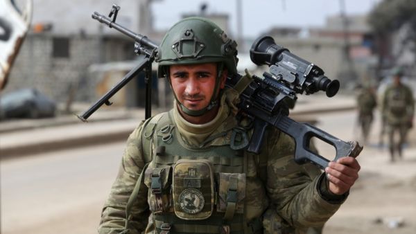 A Turkish soldier patrols with troops in the town of Atareb in the rebel-held western countryside of Syria's Aleppo province on February 19, 2020. AFP