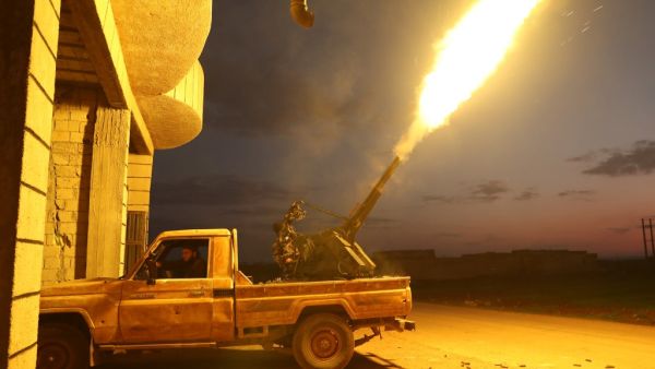 Turkish-backed Syrian fighters fire their anti-aircraft gun in the town of Sarmin, about 8 kilometres southeast of the city of Idlib in northwestern Syria, on February 24, 2020, as they take part in a military offensive on the village of Nayrab following an artillery barrage fired by Turkish forces. Omar HAJ KADOUR / AFP